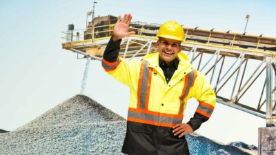 Happy miner with his had in the air.