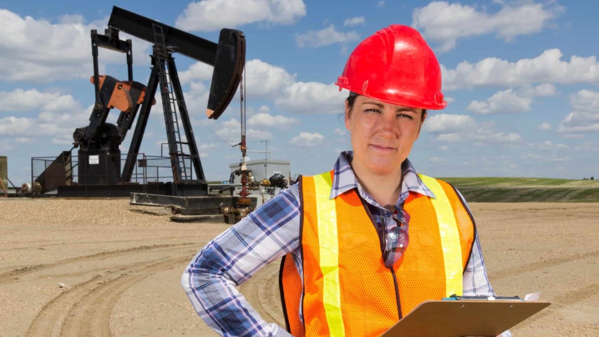 Oil rig worker standing with a clipboard.