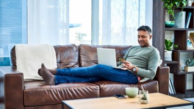 Happy man doing online shopping.