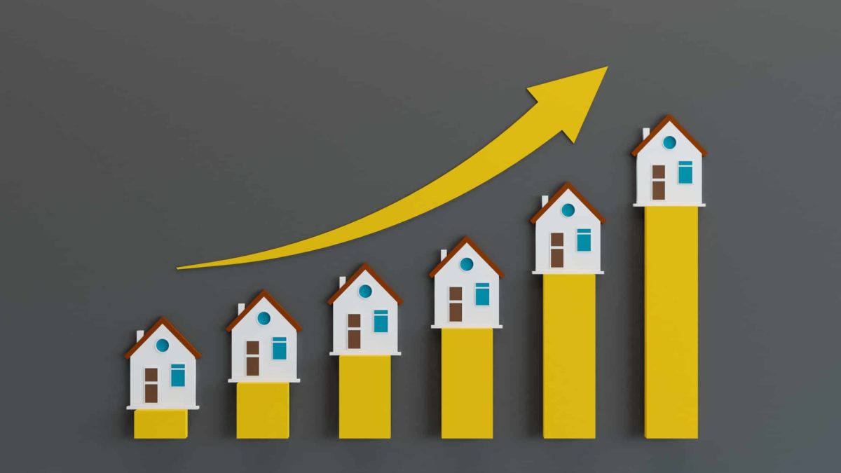 Rising real estate share price with a yellow arrow.