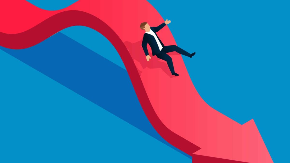 Man going down a red arrow, symbolising a sliding share price.
