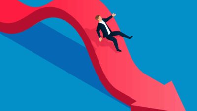 Man going down a red arrow, symbolising a sliding share price.