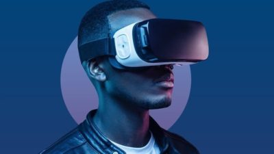 a man wears virtual reality goggles to participate in the metaverse.