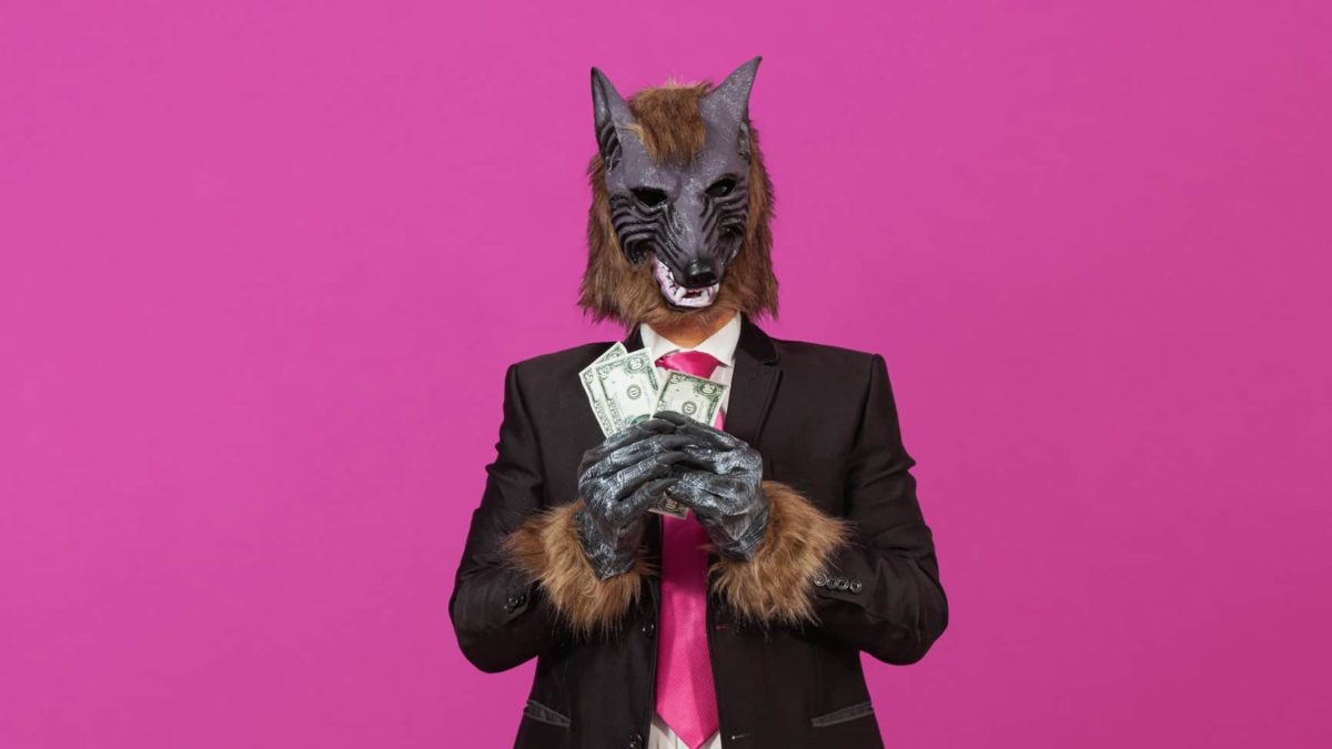 A werewolf monster holds its big dividend of cash in its paws.