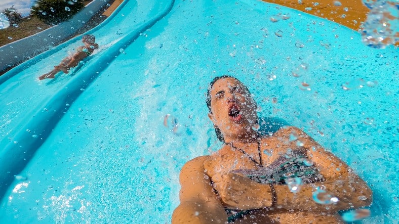 A woman slides down a massive waterslide.