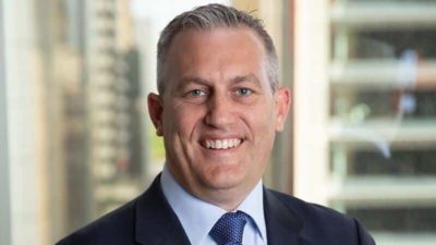 a headhsot of stockbroker Adam Dawes.