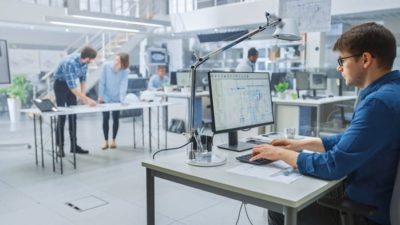 A man works at his desk in an office.