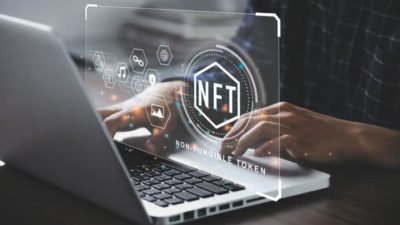 A digital image of a computer and NFT graphic